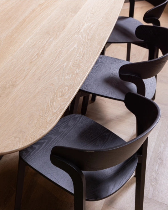 Tablo tafel van bovenaf gefotografeerd, met Crac stoelen half onder de tafel geplaatst in een strakke opstelling.